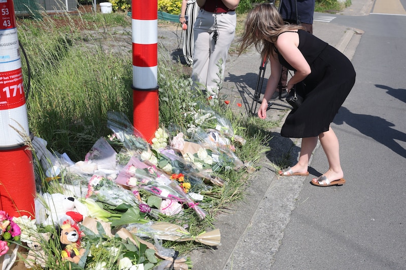 Ze leggen bloemen neer op de plek waar gisteren 2 kinderen en 2 volwassenen het leven lieten.