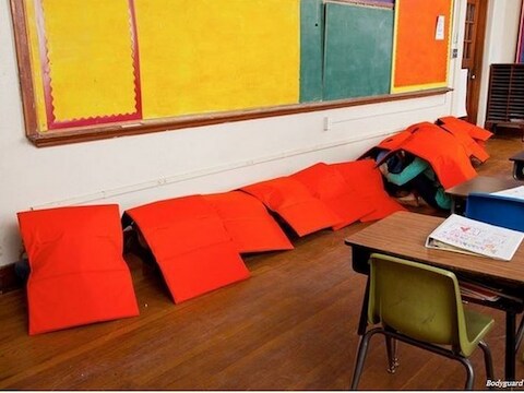 Bikkelharde realiteit: kinderen gaan naar school met een kogelvrij deken. Tornen aan de wapenwetgeving blijkt politiek een brug te ver in de VS.