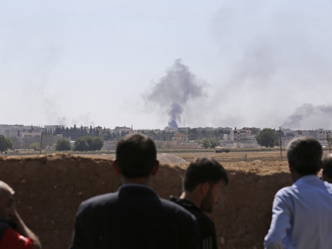 Koerden kijken aan de Turkse grens naar rookpluimen in de door IS belegerde stad Kobani.