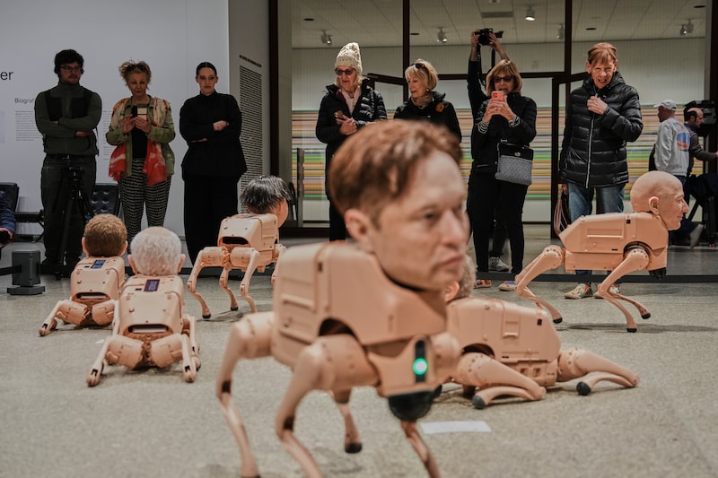 Robots resembling Elon Musk (front) and Jeff Bezos (left) are on display in Beeple artist Mike Winkelmann's installation 'Regular Animals' at the Neue Nationalgalerie in Berlin, Germany.