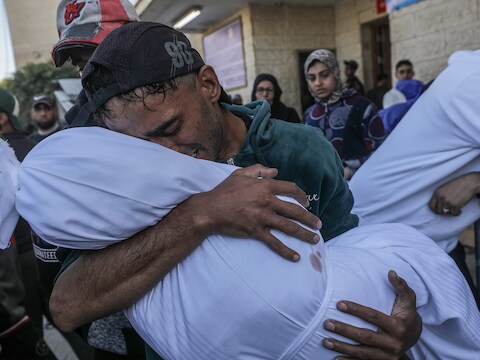 Mohammed Abu Saied treurt terwijl hij het lichaam van zijn vierjarige dochter Sila draagt, in Deir Al Balah, centraal in de Gazastrook, op 9 december 2024.