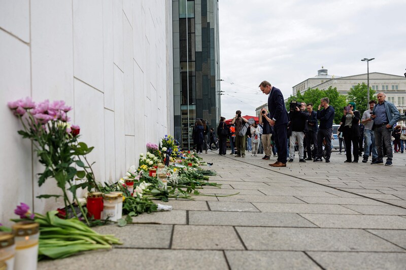 Leipzig Mayor Burkhard Jung pays his respects to the victims at a monument in Leipzig, eastern Germany, near the spot where a car crashed into the street.