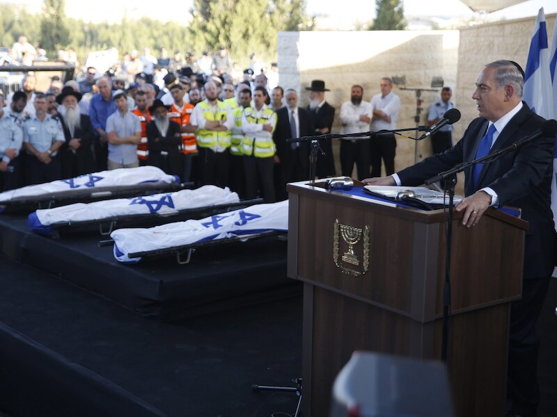 De Israëlische premier Benjamin Netanyahu tijdens de begrafenis van drie tieners.
