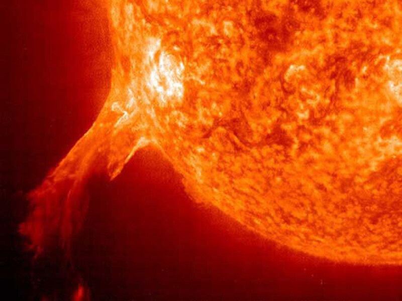 Foto van onze zon, met daarnaast een afbeelding van de Aarde om de verhouding aan te geven. © NASA.