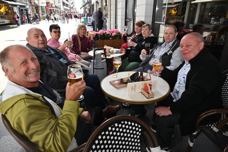 Day tripper Jozef Desmedt enjoys an aperitif by the sea with his company.