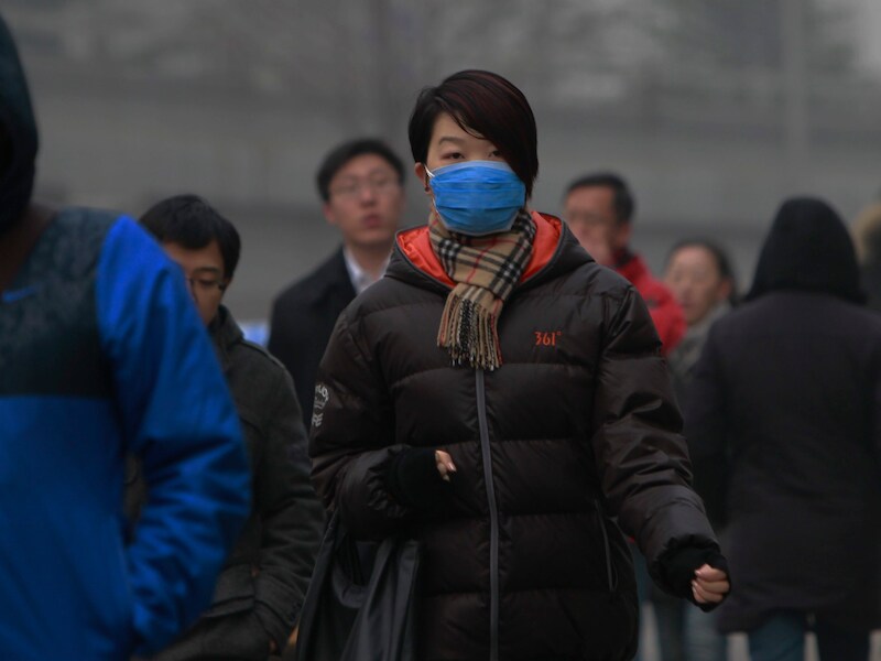 Mondmaskers moeten de inwoners van Peking beschermen tegen schadelijke stofdeeltjes.