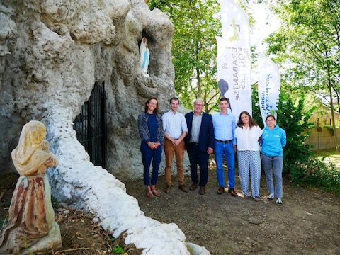 Schepen Valentine Donck, burgemeester Nicolas Celis, gedeputeerde Bart Nevens, schepen Benoit-Xavier Broze, schepen Isabelle Riera en RLBK-medewerker Ulrike Jacobs voor de gerestaureerde Lourdesgrot in de Kloostertuin.