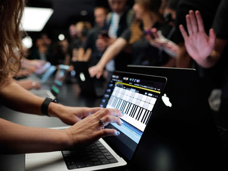 LOS ANGELES, CALIFORNIA - OCTOBER 28: Attendees view the new touchscreen MacBook Pro at the Apple “Pro and Tell” event on October 28, 2026 in Los Angeles, California. Apple CEO John Ternus unveiled the new MacBook Pro with PROLED XDR Display, the first-ever touchscreen Macbook, at the event amid a flurry of new product releases ahead of the 2026 holiday shopping season.   Mario Tama/Getty Images/AFP (Photo by MARIO TAMA / GETTY IMAGES NORTH AMERICA / Getty Images via AFP)