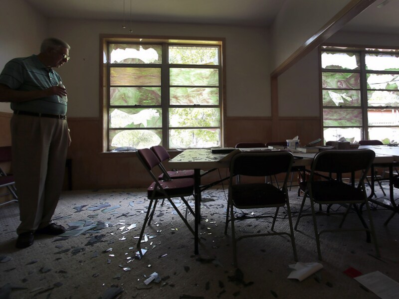 Een man overziet de schade die de explosie in een kunstmestfabriek aanrichtte in de Brethren Church in West (Texas).