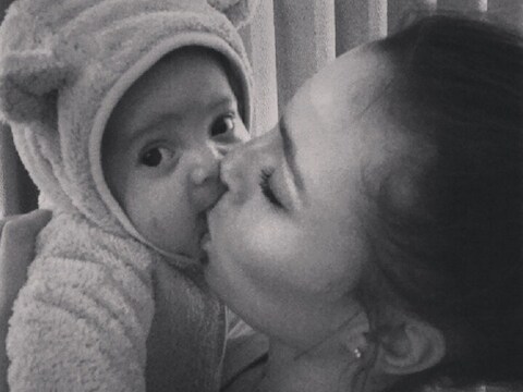 Het in een schattig berenpakje getooide zoontje van Moussa Dembélé krijgt een dikke knuffel van mama Naomi.