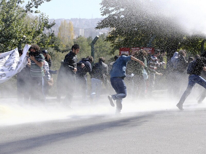 Demonstranten worden met het waterkanon uit elkaar gedreven in Ankara.