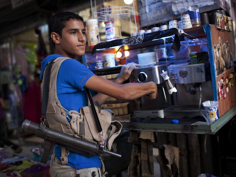 Ook in het winkeldistrict van Aleppo domineren wapens het straatbeeld.