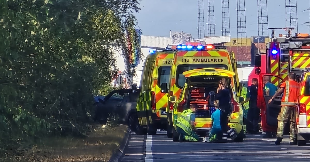 Emergency vehicles and forensic experts at the scene of a fatal head-on car crash on an industrial road in Kallo.