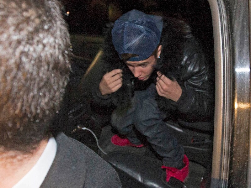 Omgeven door security-agenten arriveert Justin Bieber aan een politiekantoor in de Canadese grootstad Toronto.