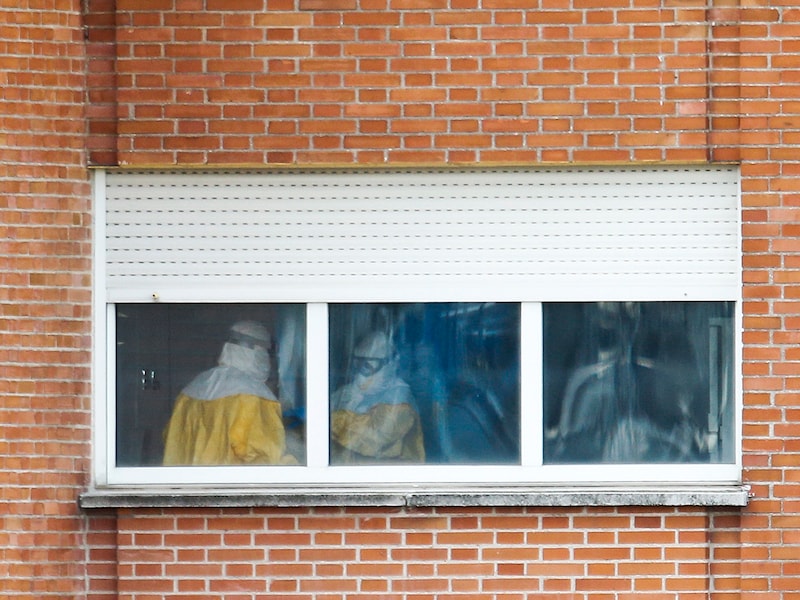 Verplegers in beschermkledij in het Carlos III-ziekenhuis in Madrid waar de 44-jarige ebolapatiënte wordt behandeld.