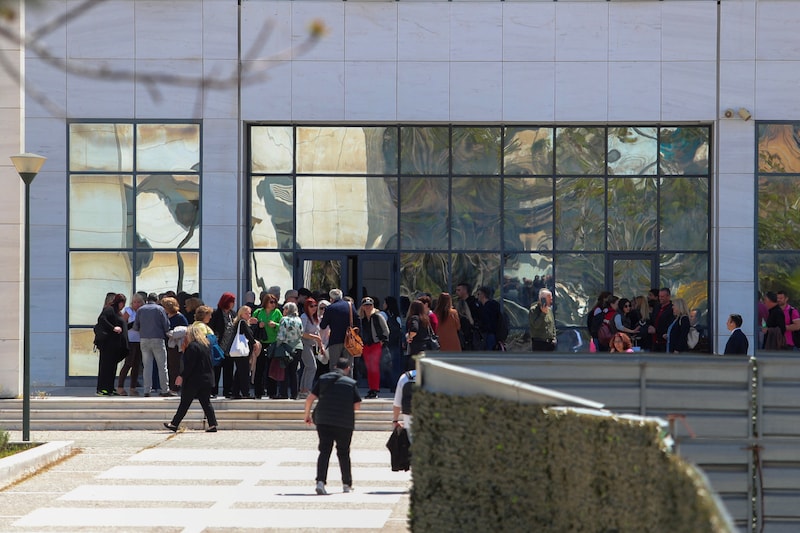 People gather outside the Court of Appeal in Athens after a shooting that left several people injured.