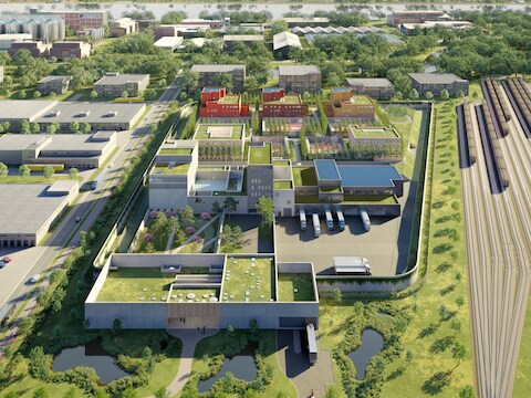 Vooraan een onthaalgebouw, daarachter een servicegebouw voor bezoekers en personeel en achteraan vijf blokken met de cellen. 