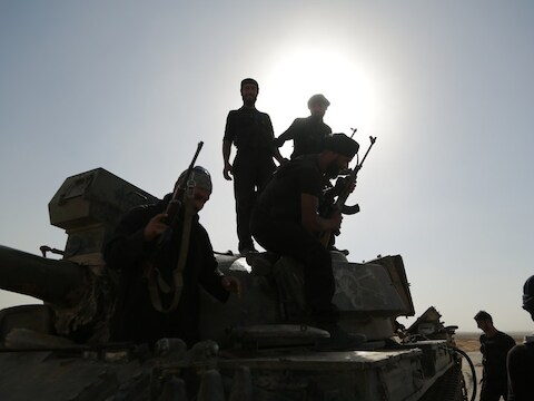 Syrische rebellen inspecteren een legertank in de stad Raqqah.
