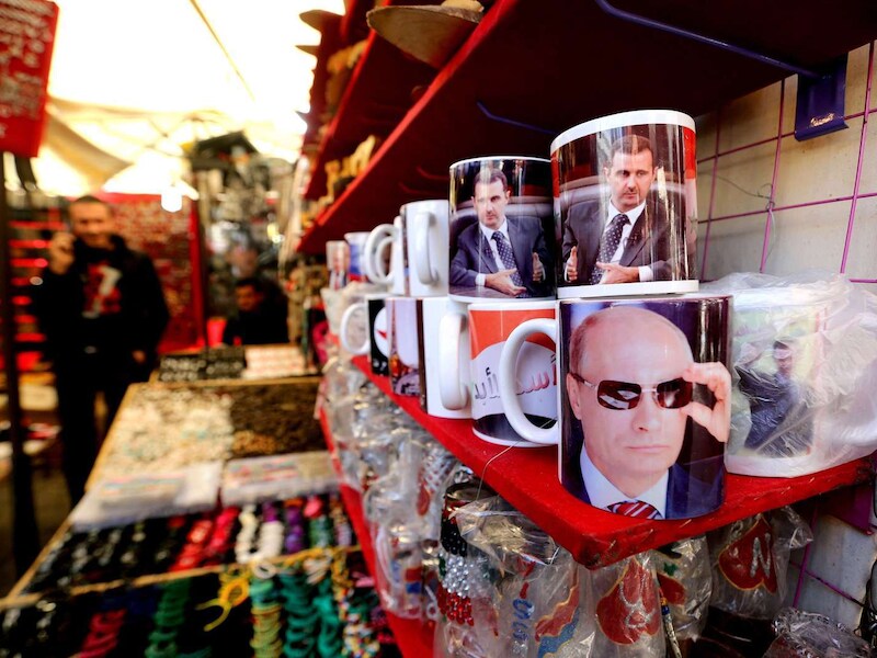 Een winkeltje in Damascus verkoopt mokken met een foto van Poetin of Assad.