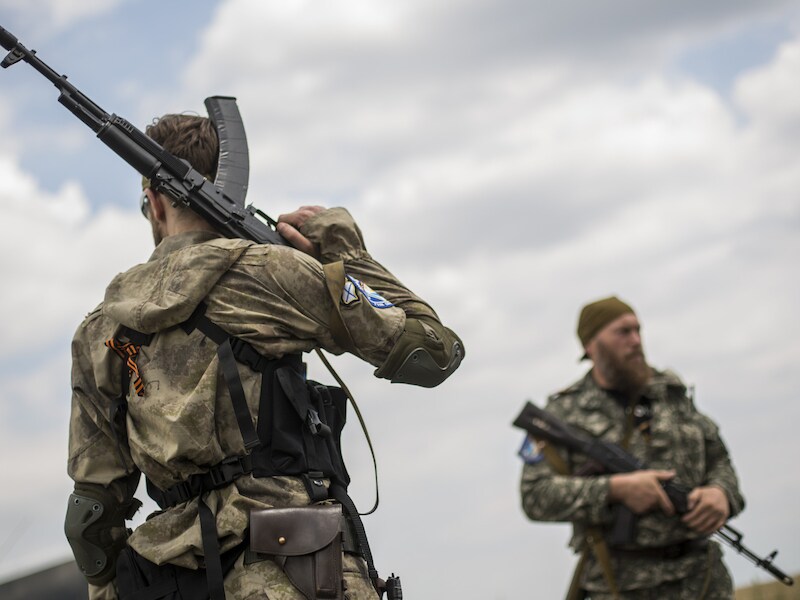 Gewapende pro-Russische rebellen houden de wacht bij de crashsite.