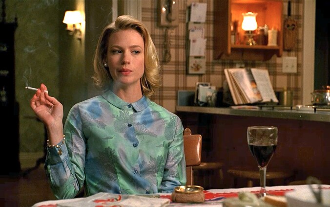 De kettingrokende Betty Draper uit de serie Mad Men die wel van een glaasje houdt.