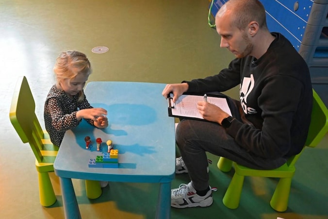 Een leerkracht neemt een KOALA-test af bij een kindje uit de derde kleuterklas.