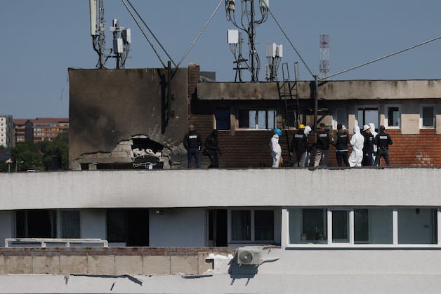 Romanian investigators at the site of the impact in the apartment building in Galati, along the border with Ukraine.