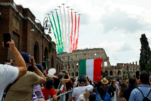 The Italian Air Force's aerial acrobatics demonstration team, the Frecce Tricolori (Tricolored Arrows), flies over the Colosseum.