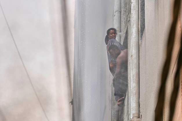 A family tries to escape through the window.