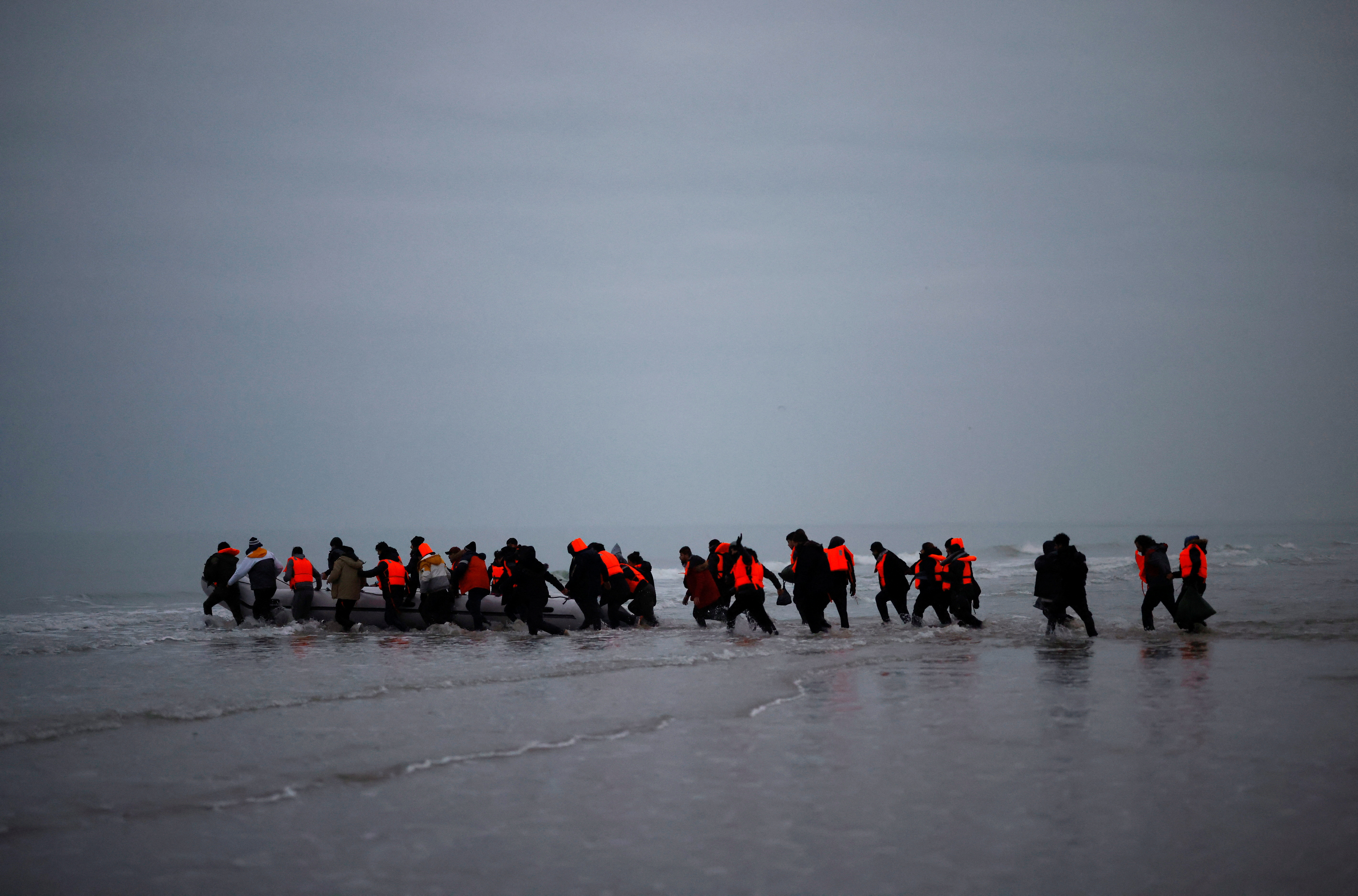 Een groep migranten verlaat de Franse kust en gaat in een rubberbootje op weg naar het VK. Foto van half december vorig jaar.
