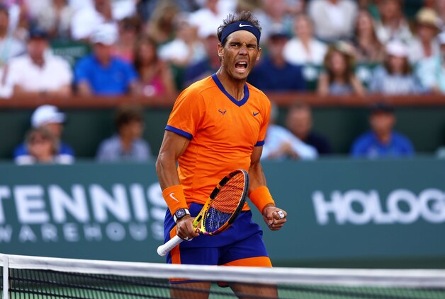 INDIAN WELLS, CALIFORNIA - MARCH 20: Rafael Nadal of Spain celebrates a point against Taylor Fritz of the United States in the men's Final on Day 14 of the BNP Paribas Open at the Indian Wells Tennis Garden on March 20, 2022 in Indian Wells, California.   Clive Brunskill/Getty Images/AFP
== FOR NEWSPAPERS, INTERNET, TELCOS & TELEVISION USE ONLY ==
