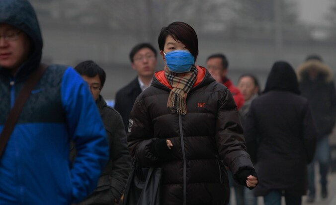 Mondmaskers moeten de inwoners van Peking beschermen tegen schadelijke stofdeeltjes.