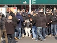 Fans van Ajax kregen het vanmiddag aan de stok met Italiaanse demonstranten, die de bus van de Ajaxfans blokkeerden.