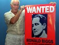 Foto uit 1994. Ronny Biggs toont een poster met zijn beeltenis op.
