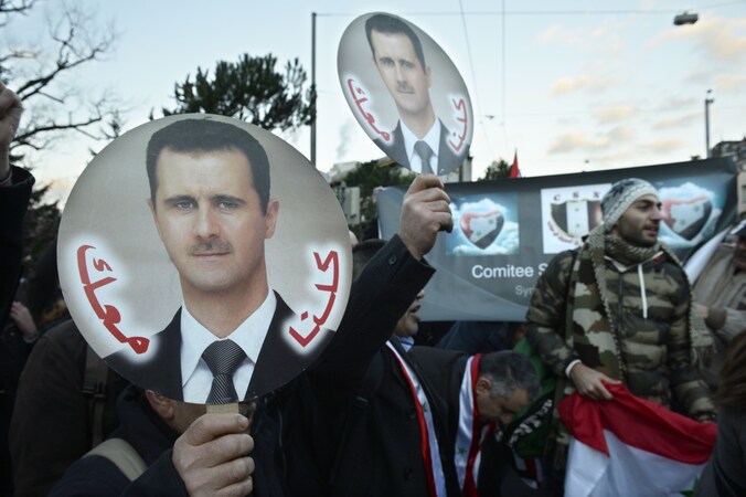 Aanhangers van Assad demonstreren in het Zwitserse Montreux. Foto uit januari 2014.