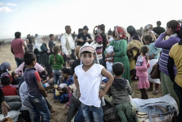 Syrische vluchtelingen bij de grens met Turkije.