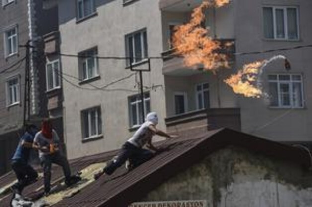 Linkse demonstranten gooien molotovcocktails tijdens schermutselingen met de Turkse oproerpolitie in het district Gazi in Istanbul. Het protest is gericht op de opstelling van de Turkse regering inzake het conflict in Syrië.