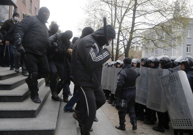 Pro-Russische activisten verlaten vanochtend het gebouw van de openbare aanklager in Donetsk.