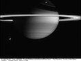 Titan (links onderaan) is de grootste maan van Saturnus.