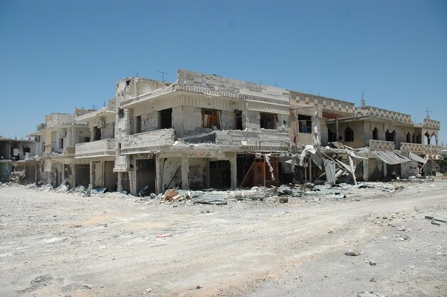 Beschadigde gebouwen in de Syrische stad Qusair