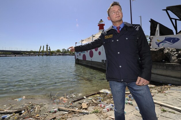 Woordvoerder van de politie, Roman Hahslinger, wijst naar het water waar het lichaam van de Libische ex-premier werd teruggevonden.