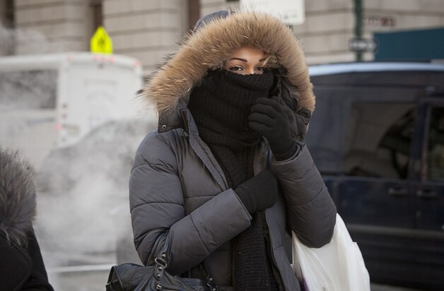 Een vrouw in New York beschermt zichzelf tegen de kou.