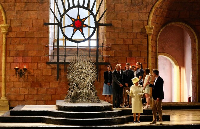 Queen Elizabeth II samen met prins Philip en de cast van 'Game of Thrones' bij de IJzeren Troon.