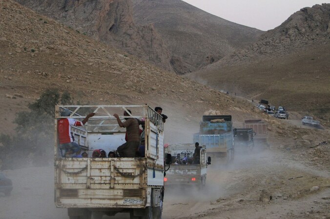 Yezidi-vluchtelingen worden geëvacueerd uit het Sinjargebergte door Koerdische troepen.