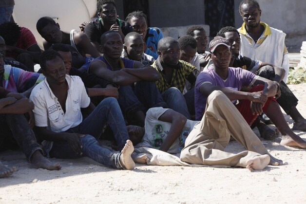 Afrikaanse migranten die zijn gered door de Libische kustwacht nadat hun boot zonk voor de kust van Libië.