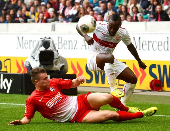 Arthur Boka probeert een tackle van Felix Klaus (Freiburg) te ontwijken.