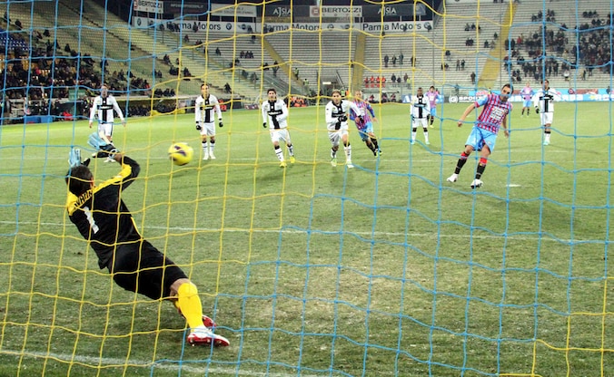 Catania-speler Lodi vloert Parma-goalie Pavarini.