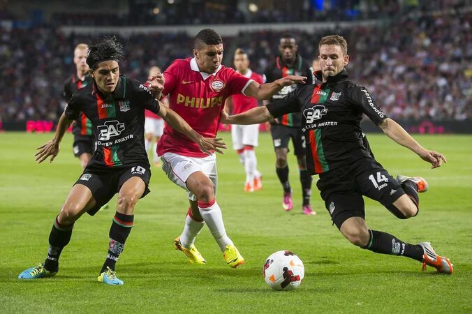 Zakaria Bakkali (midden) van PSV slalomt tussen Kevin Conboy (rechts) en Navarone Foor van NEC door.