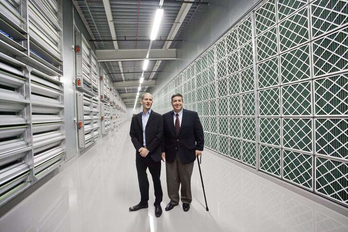 Tom Furlong, Vice President, Facebook Site Operations en Joel Kjellgren, Data Centre Manager, staan in de serverhal van het nieuwe datacenter.