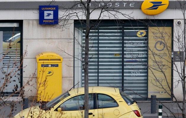 Het postkantoor waar de rolluiken nu naar beneden zijn.